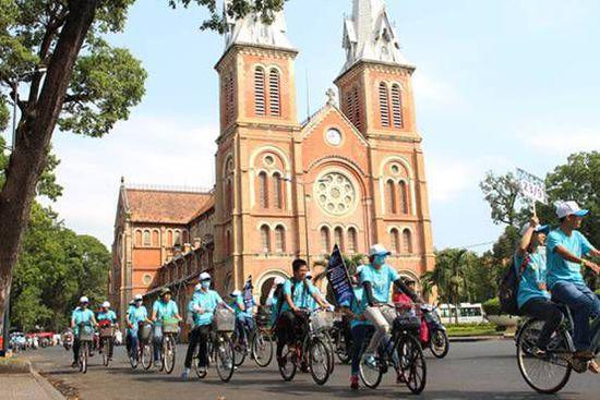 数百名绿色运动青年志愿者骑自行车在胡志明市中心环行，以支持和推动保护地球环保一小时活动。（图片：越南青年人报）